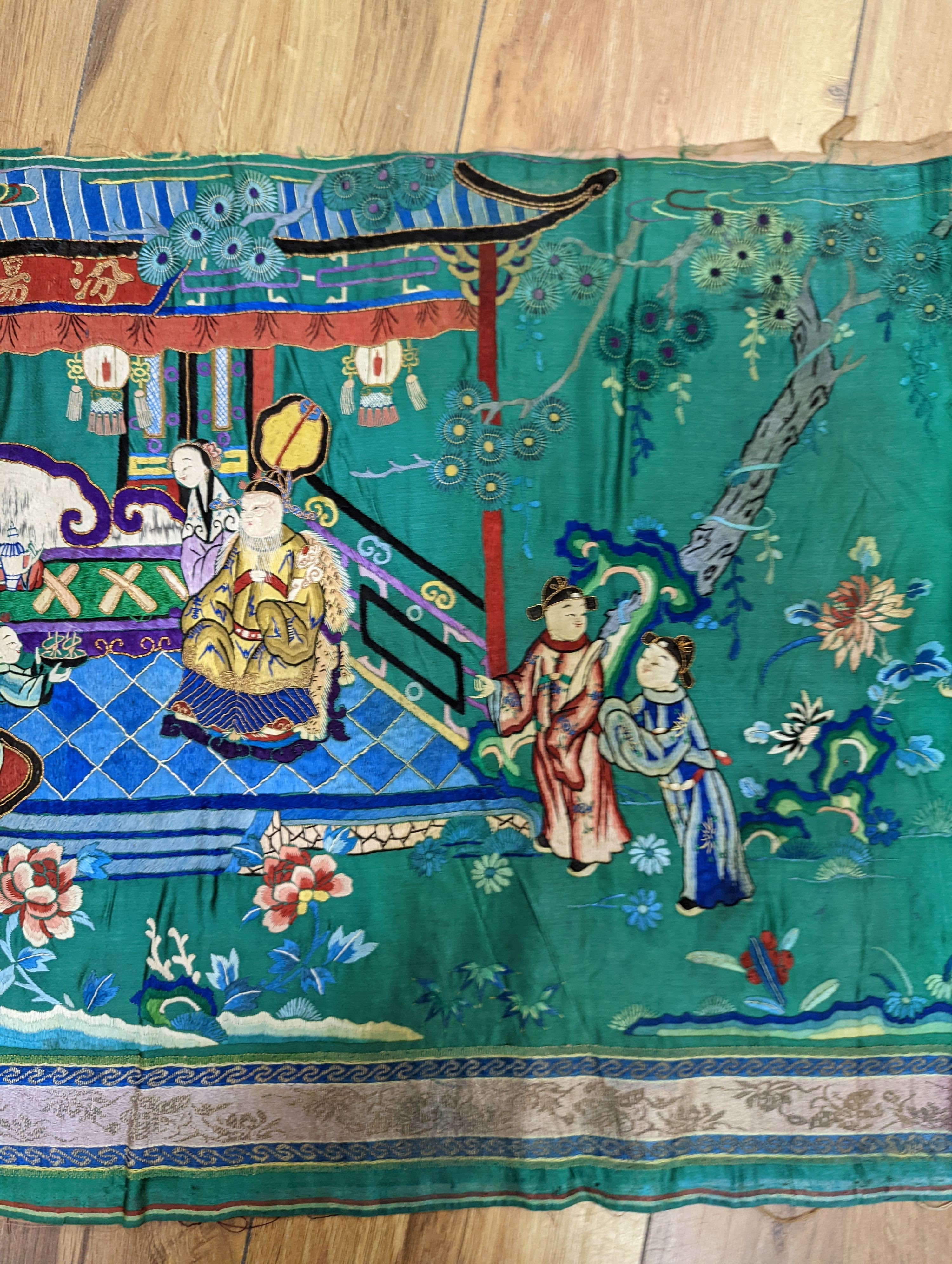 An early 20th century Chinese silk figurative embroidery from a larger panel of an emperor and empress scene.